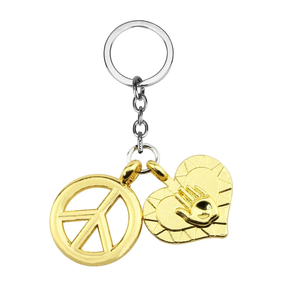 Gold pendant necklace featuring a peace sign and a stylized face design.