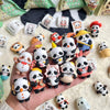 A hand holds a collection of blind box panda figures in various poses and colors against a white background.
