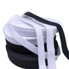 Stack of white and black polyester elastic bands for sewing and crafts