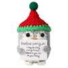 Handmade crochet penguin doll with a red hat and an inspirational card