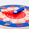 A wooden clock face with a blue hand pointing to the 10 o'clock position, used as a Montessori educational toy.