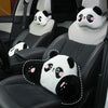 Black car seats with white panda plush headrests and lumbar support cushions