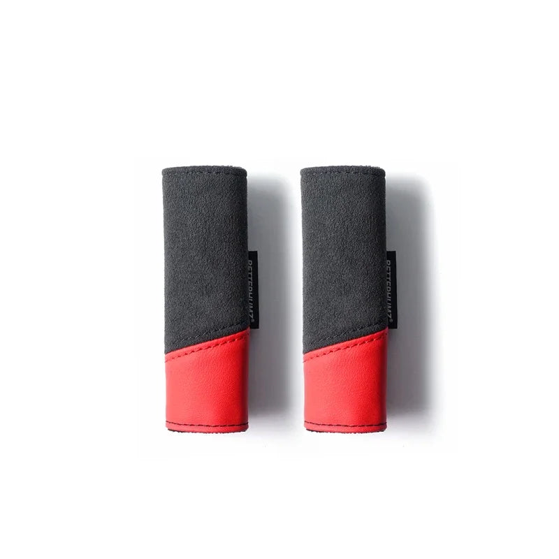A pair of black and red Audi Alcantara grab handle protector covers with card pockets.