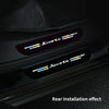 Close-up of black car door sill protector strips with a sports theme decoration.
