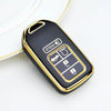 A black and gold TPU protective key case for a Honda vehicle is shown on a white surface.