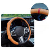Close-up view of a tan leather steering wheel cover installed on a car's interior.