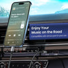 A smartphone is connected to an AUX port in a car, demonstrating the use of a USB-C to 3.5mm audio adapter.