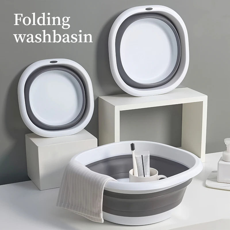 A set of white and gray folding washbasins displayed on a light surface.