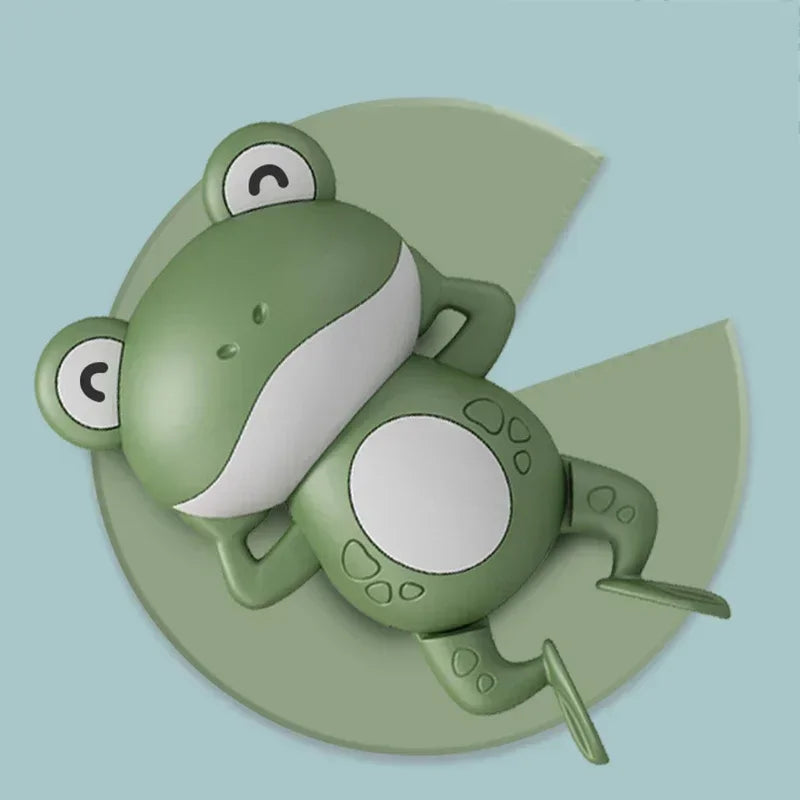 A green musical bubble maker bath toy shaped like a frog sitting on a light green background.