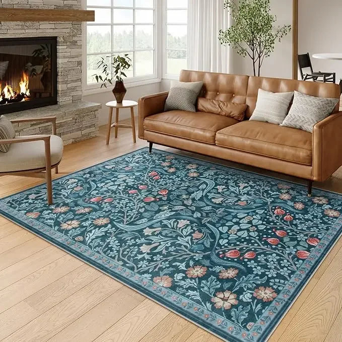 A vintage floral soft area rug featuring blue and green botanical patterns in a living room setting.