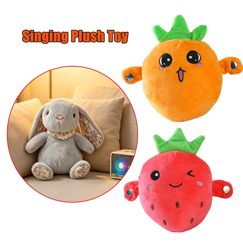 An orange singing plush toy shaped like a fruit, next to a gray bunny plush toy.