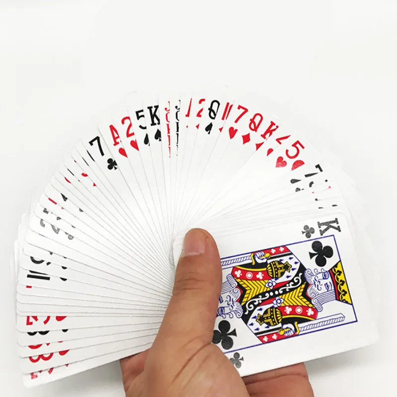 A hand holds a fan of waterproof playing cards showing various face cards and numbered cards.