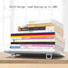 Aluminum portable laptop stand with adjustable legs supporting a stack of books.