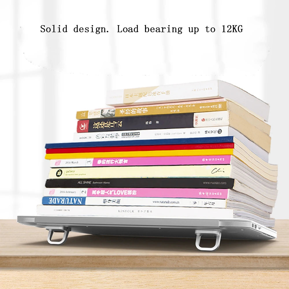 Aluminum portable laptop stand with adjustable legs supporting a stack of books.