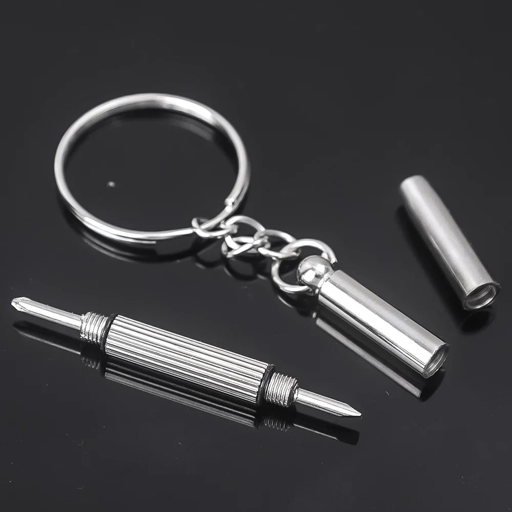 Silver nose pads and a mini screwdriver attached to a metal ring for glasses repair