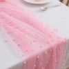 Pink pearl beaded tulle table runner draped on a white tablecloth for an event.