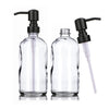 A clear glass soap dispenser set featuring two bottles with black pumps.