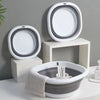 A set of three white and gray foldable plastic wash basins or bowls for laundry, camping, and travel.
