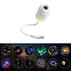A white mini galaxy star projector night light with a flexible cord and lens, shown alongside various celestial images.