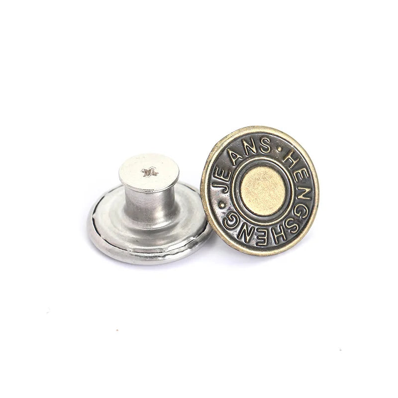 A round brass button with the engraved text Jeans Heng shown on a silver repair kit.