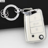 A silver TPU car key cover with a ring and fob is shown against a dark background.