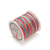 A spool of bright, multi-colored nylon macramé cord for jewelry making.