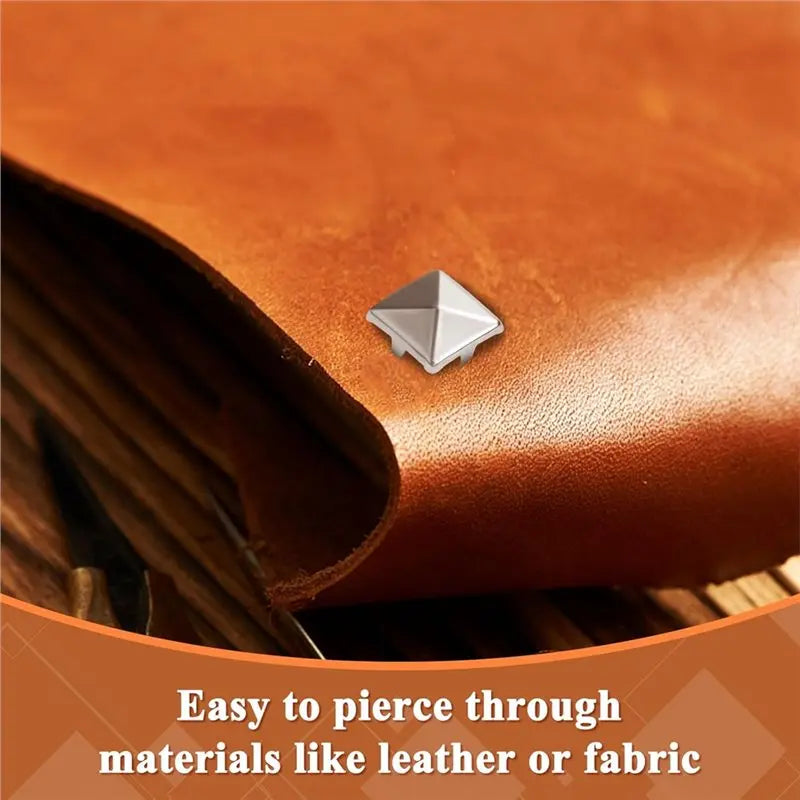 Silver metal pyramid studs with four prongs piercing through brown leather fabric