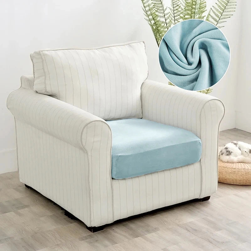 A cream upholstered armchair with a light blue seat cover and a circular blue fabric swirl detail.