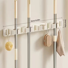 Wall-mounted metal holder for mop and broom with detachable hooks and storage shelves