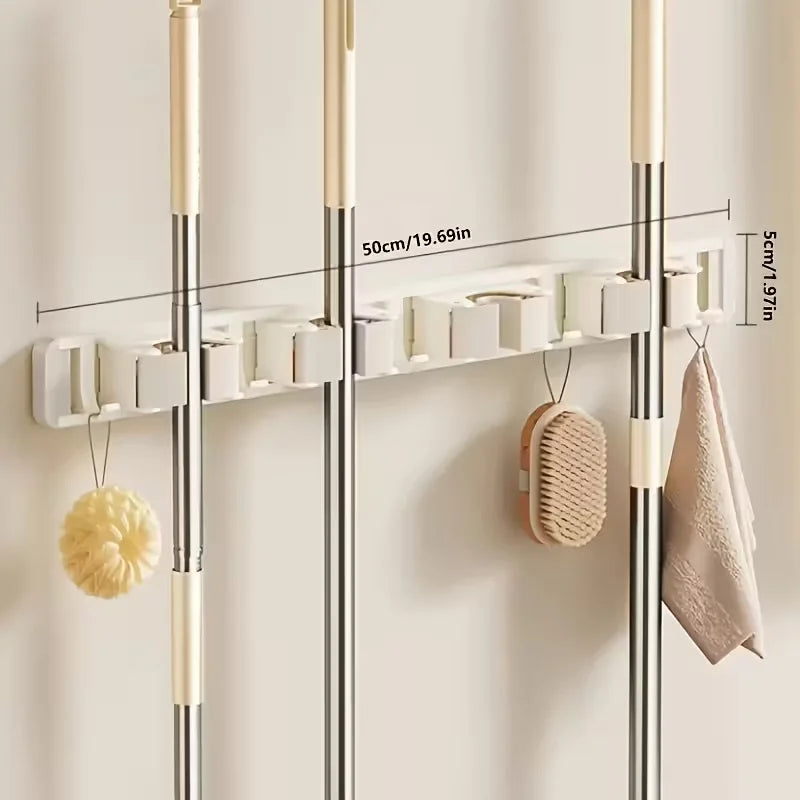 Wall-mounted metal holder for mop and broom with detachable hooks and storage shelves