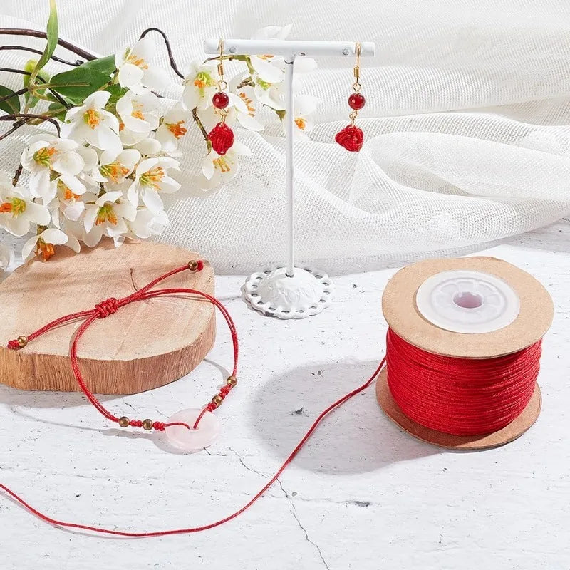 Red nylon cord for jewelry making with beads and a hanging display stand