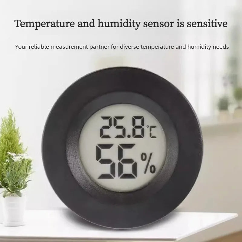 A black mini digital hygrometer thermometer displaying 25.8°C and 56% humidity.