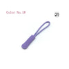 A purple plastic zipper pull is shown against a white background.