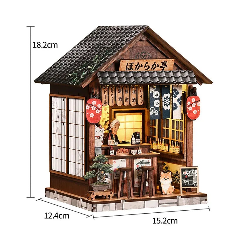 A miniature wooden Japanese tea house model featuring a tiled roof, sliding doors, and decorative elements.