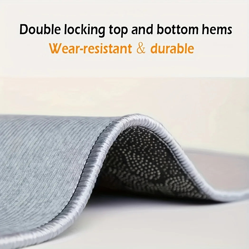 Close-up of a gray doormat with double locking top and bottom hems showing its texture.