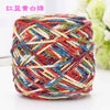 A ball of multi-colored silk crochet yarn featuring red, blue, white, and yellow threads.