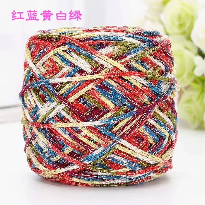 A ball of multi-colored silk crochet yarn featuring red, blue, white, and yellow threads.