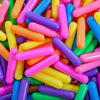 A close-up view of a large pile of colorful, translucent plastic ball pit balls in various bright colors.