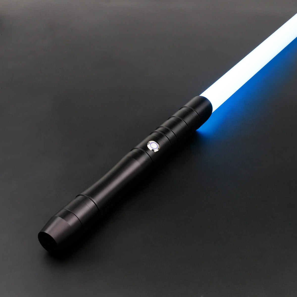 A black lightsaber with a blue laser blade is shown diagonally on a dark surface.