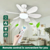 A hand holds a white remote control for an LED ceiling fan light, with the fan mounted on a white ceiling.