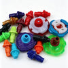 A collection of colorful plastic spinning top customization accessories and parts arranged on a white background.