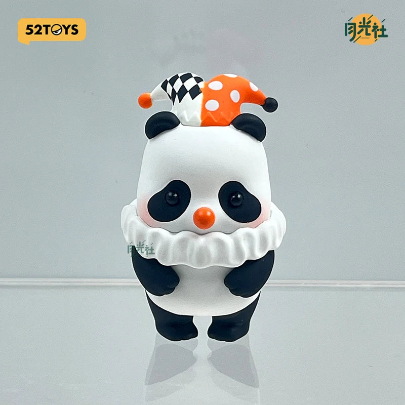 A white and black blind box figure of a panda with an orange and white polka-dot hat.