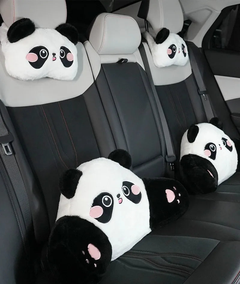 Black car seats with white panda plush headrests and lumbar support cushions.