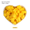 A pile of yellow silicone star heart beads for DIY jewelry making