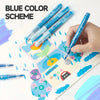 A hand holds a set of blue color scheme paint markers with soft brush tips on watercolor paper.