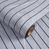 Roll of gray marble peel-and-stick wallpaper featuring thin black stripes and subtle veining.