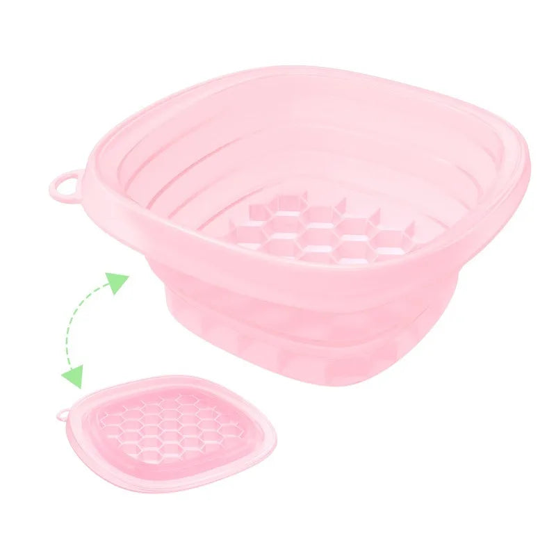 A pink foldable silicone ice bath and facial massage bowl with a removable tray.