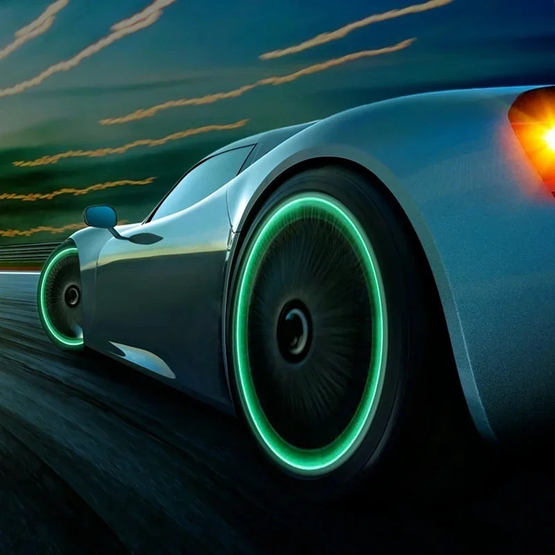 A close-up of a car tire showing luminous valve caps with a bright green glow in motion.