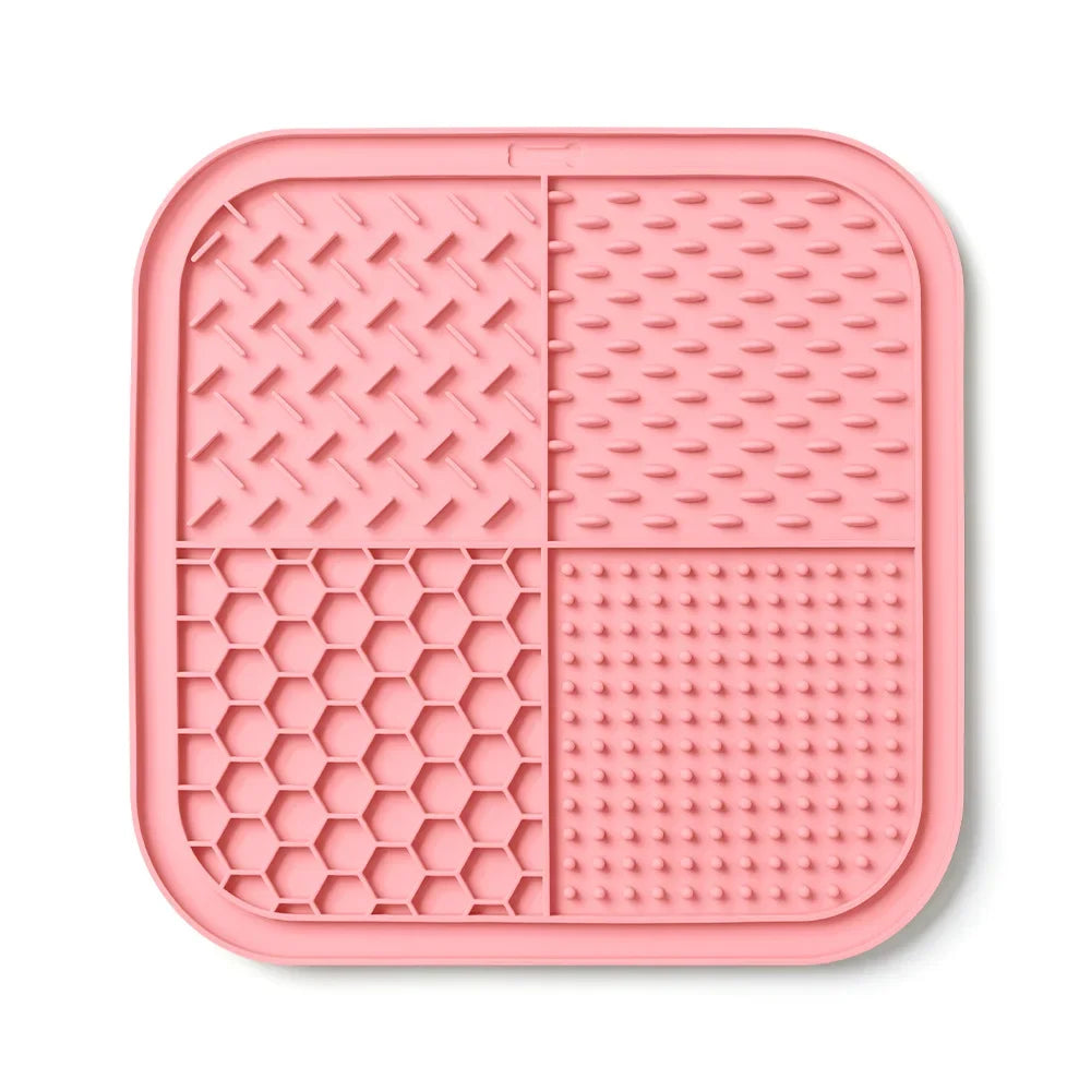 Pink silicone lick mat for dogs and cats with suction cups divided into four sections