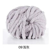 A ball of light gray chunky acrylic yarn used for knitting and crochet